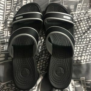 Black low-heeled Croc sandals